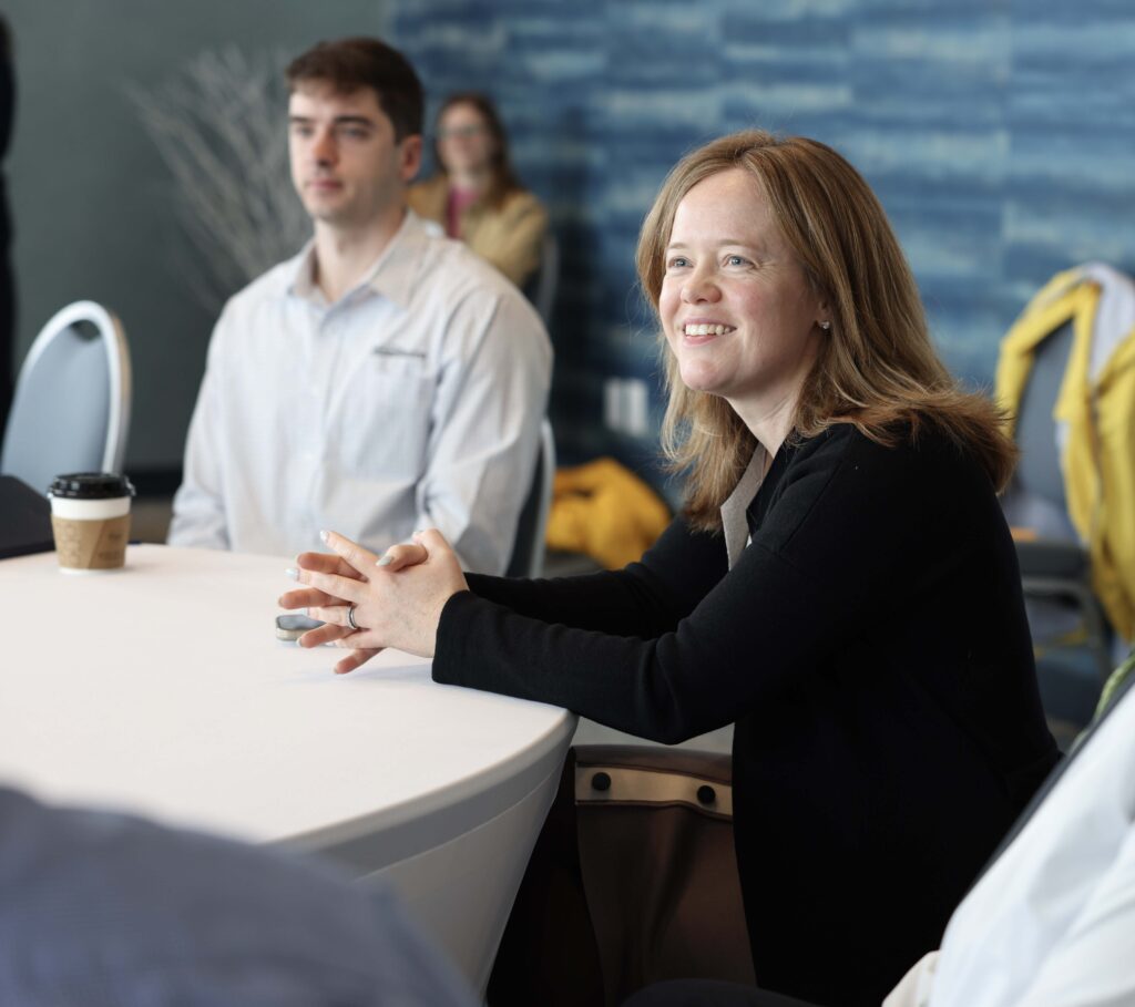 a group of people sitting around a white table