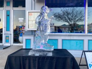 an ice sculpture is displayed in front of a store