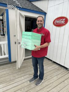 a man is holding a large stack of boxes