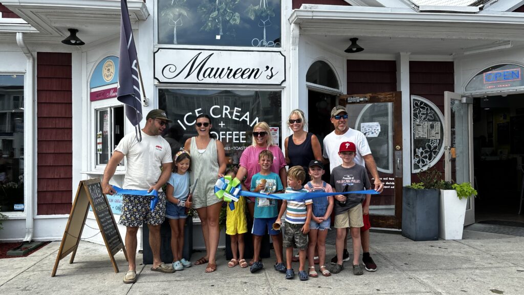 a group of people standing in front of a store