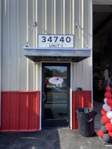 the entrance to a building with balloons in front of it