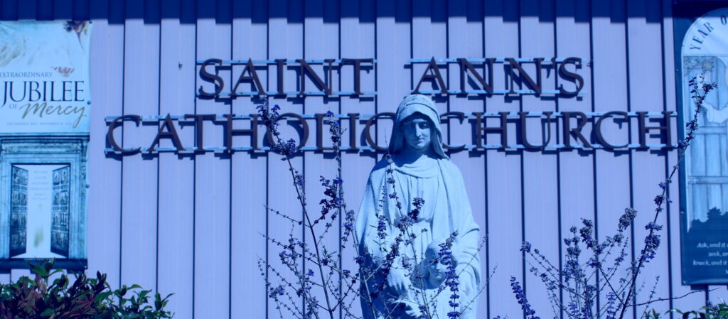 a statue of a person standing in front of a building