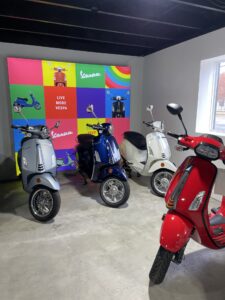 a group of scooters parked next to each other in a room